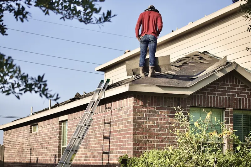 Professional roofer working on a residential roof in Country Club Harbor